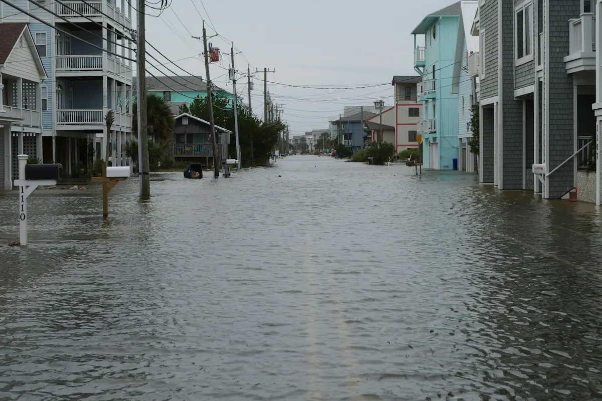 Street flooded between raised coastal homes