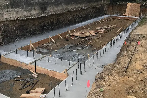 Formed footing trench with steel dowels for a new slab foundation