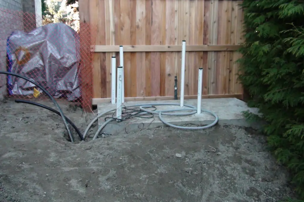 New concrete pool equipment pad with pipe and conduit stubs before the equipment is set