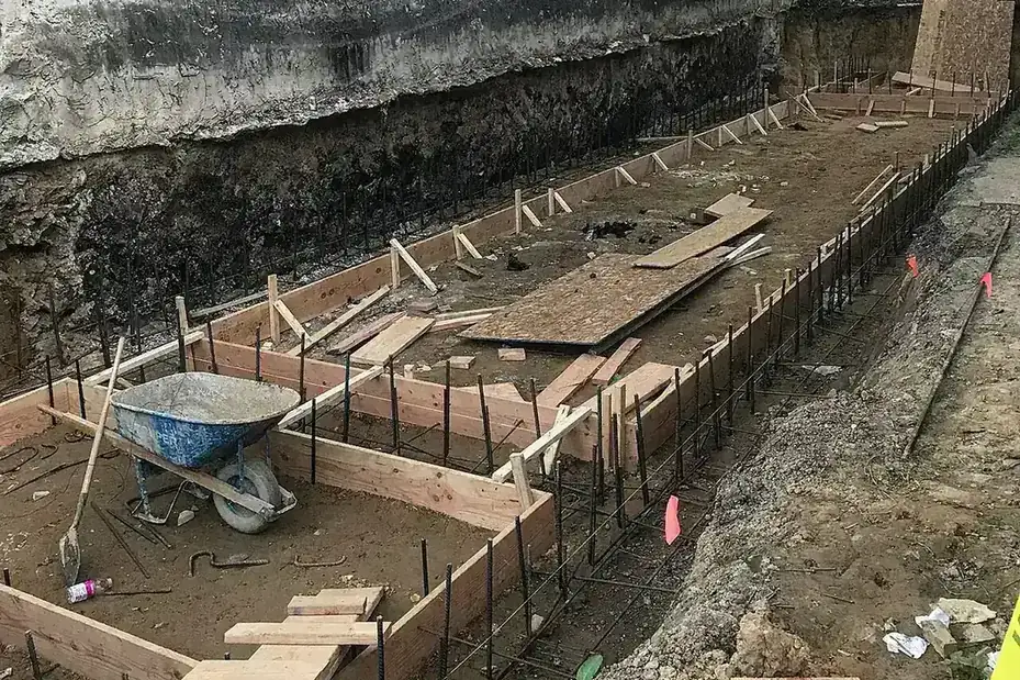 Wood forms, rebar and a wheelbarrow set for a concrete pour