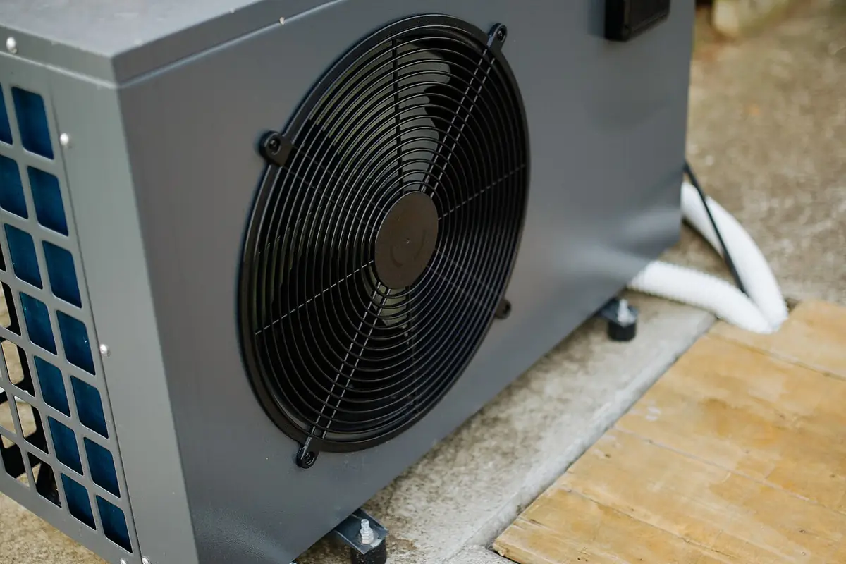 Pool heat pump unit standing on a concrete slab