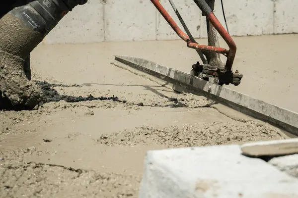 Power screed on fresh concrete