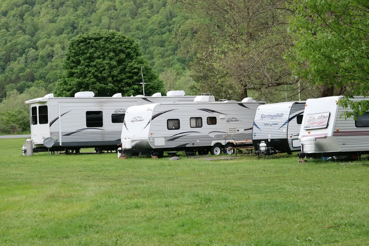 Row of travel trailers parked on grass